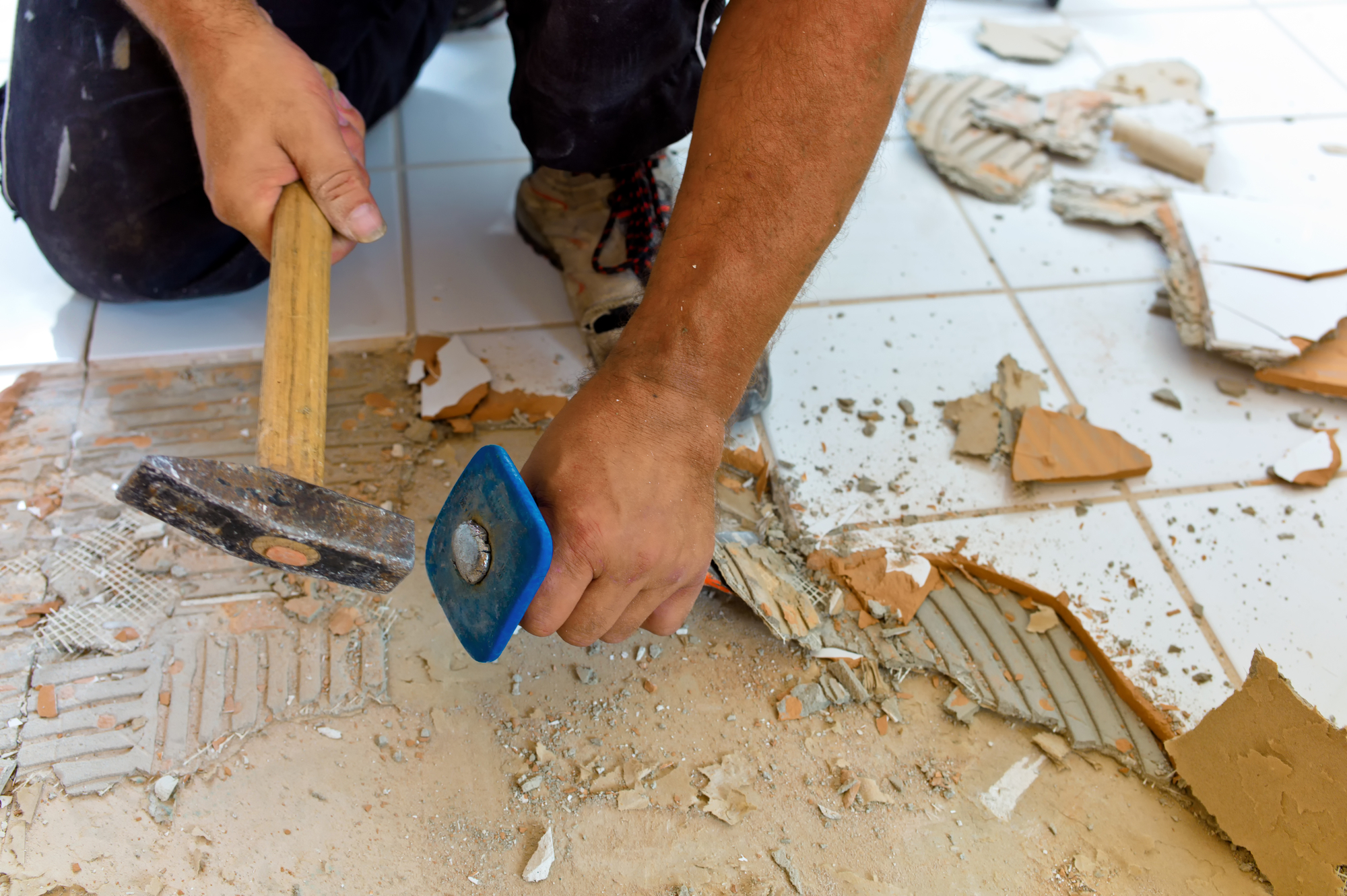 broken tiles in the renovation of a bathroom. remodeling and renovation in the living area. tiler at work